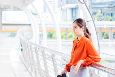 Side view of young woman looking at camera