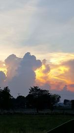 Scenic view of field against sky at sunset