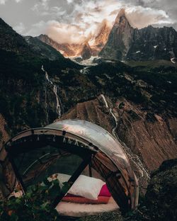 Bridge over mountains against sky