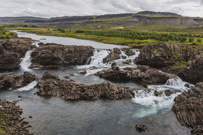 Scenic view of river flowing through rocks