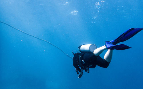 Man scuba diving while swimming in sea