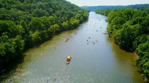 High angle view of people on river amidst trees