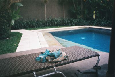 High angle view of chair by swimming pool