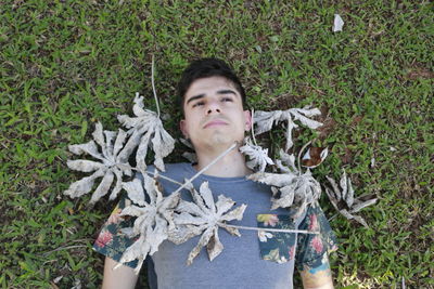 Directly above shot of man lying on field at park