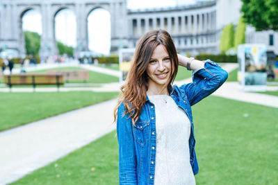 Portrait of smiling young woman standing outdoors