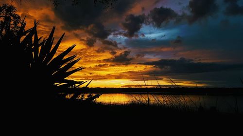 Scenic view of sea against orange sky