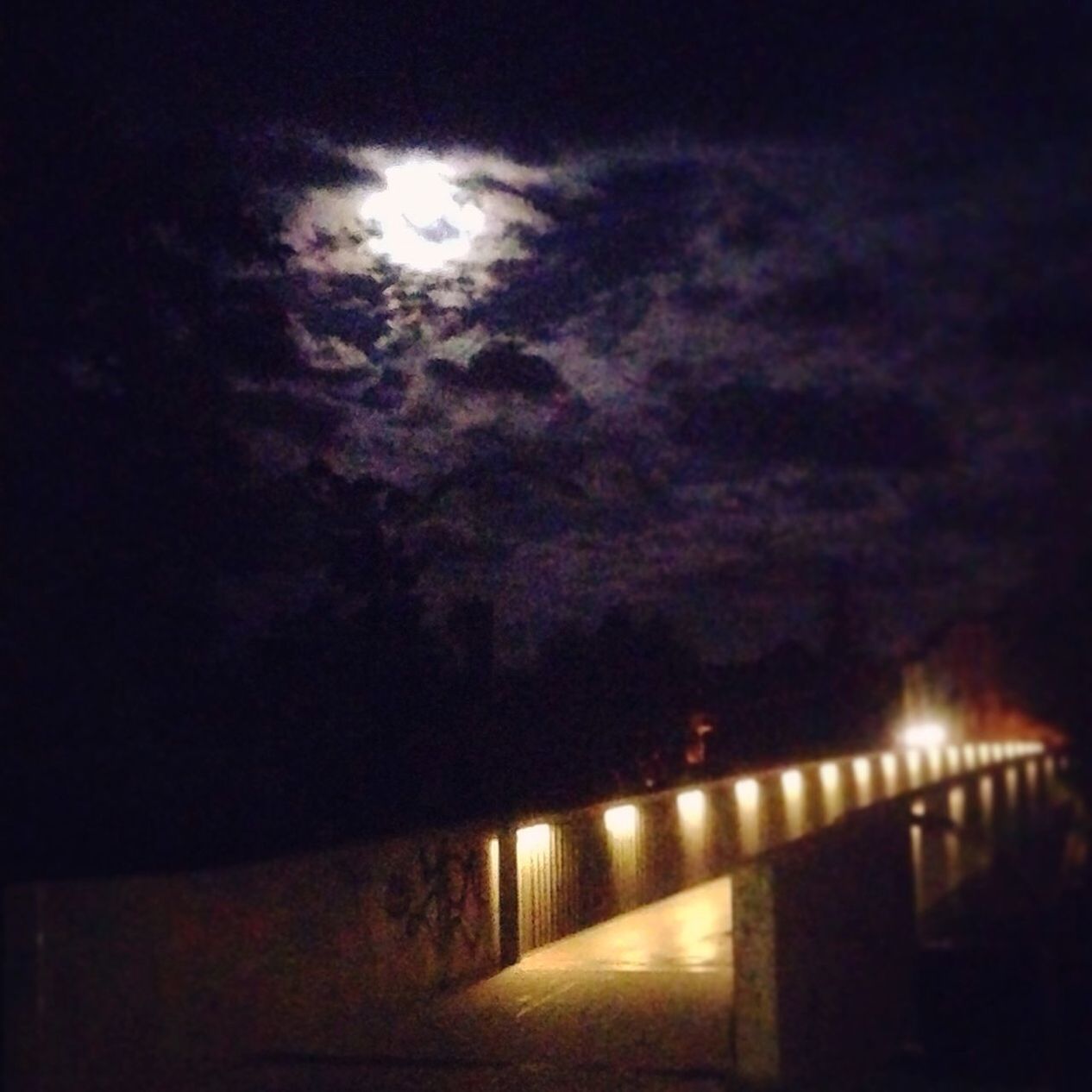 sky, night, illuminated, built structure, architecture, cloud - sky, dark, dusk, silhouette, weather, water, connection, railing, cloudy, the way forward, outdoors, no people, bridge - man made structure, nature, building exterior