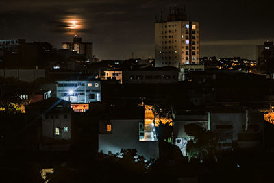 High angle view of illuminated buildings in city at night