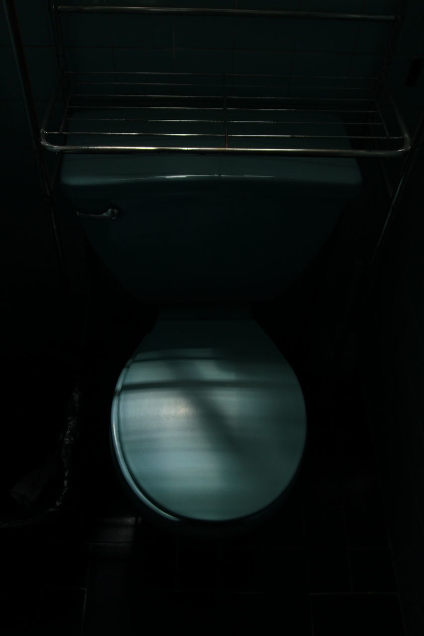 indoors, illuminated, no people, lighting equipment, close-up, light, dark, high angle view, vehicle interior, technology, transportation, electric light, domestic room, rail transportation, reflection, toilet, seat, bathroom, mirror, glowing, light fixture