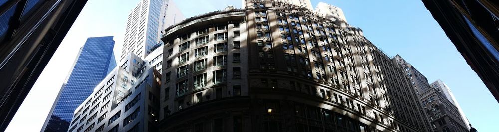 Low angle view of buildings against sky in city