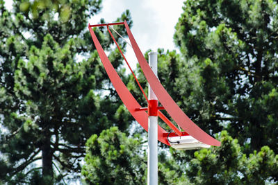 Low angle view of information sign against trees in forest