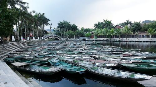 Boats moored at shore against sky