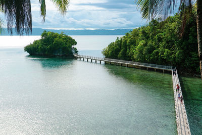 Scenic view of swimming pool by sea against sky