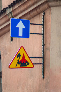 Close-up of road sign on wall