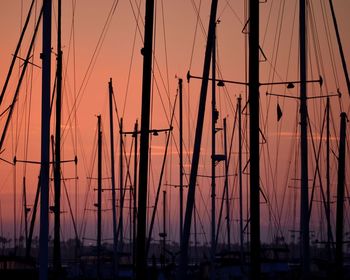 Sailboats in sea during sunset