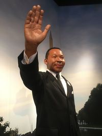 Low angle view of young man standing in park against sky