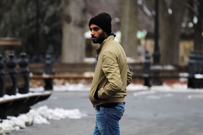 Man walking on footpath in city