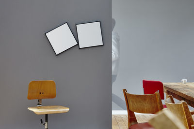 Empty chairs and table against wall at home