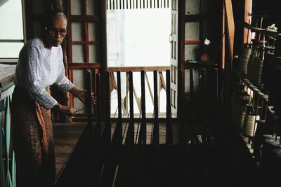 Senior woman operating machinery in workshop