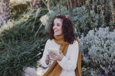 Portrait of smiling woman standing in snow