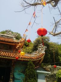 Low angle view of lanterns hanging against sky