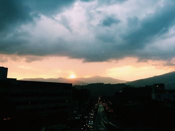 Silhouette cityscape against sky during sunset