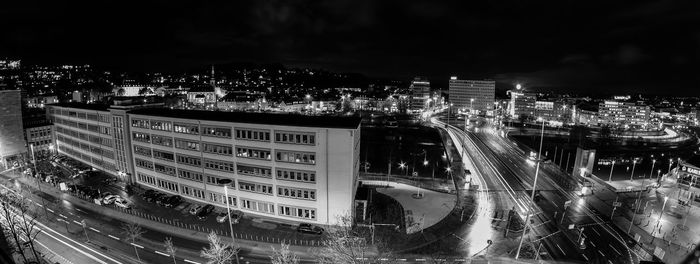 High angle view of street amidst buildings in city at night