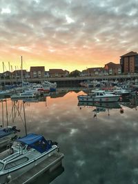 High angle view of boats moored at harbor during sunset