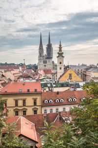 Buildings in town against sky