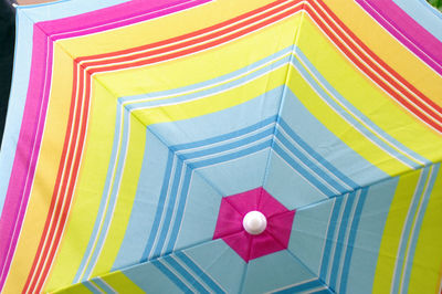 Low angle full frame view of multi summer bright colored umbrella