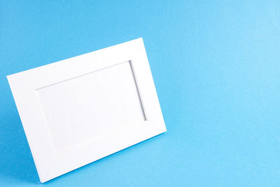 High angle view of white table against blue background