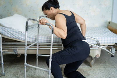 Side view of woman exercising in gym