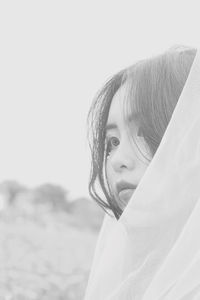 Close-up of thoughtful bride against clear sky