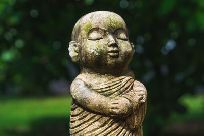 Close-up of buddha statue in park
