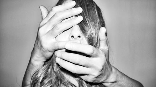 Close-up portrait of a girl covering face