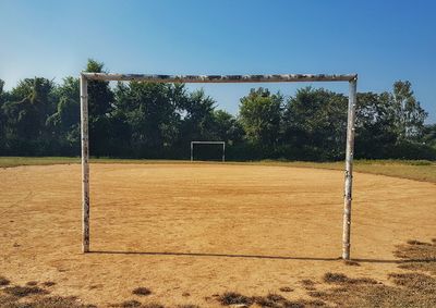 Goal post at soccer field against clear sky