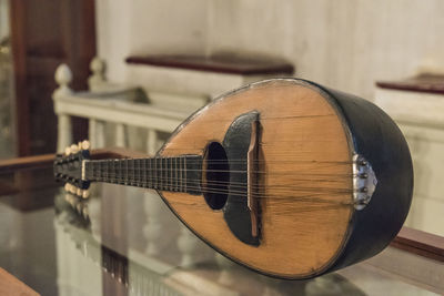 Close-up of guitar playing at home