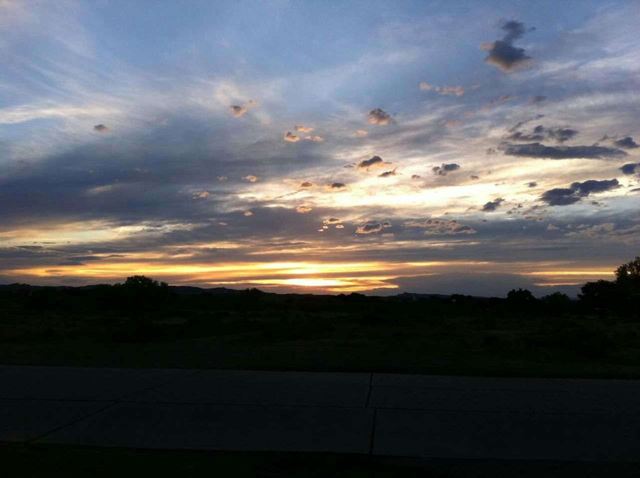 sunset, silhouette, sky, scenics, tranquil scene, orange color, beauty in nature, tranquility, sun, cloud - sky, landscape, nature, idyllic, cloud, sunlight, tree, outdoors, no people, dramatic sky, sunbeam