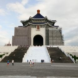 People at temple against sky