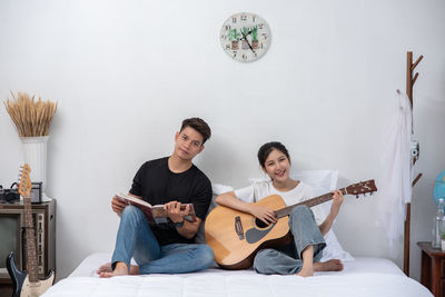 Young couple sitting on guitar