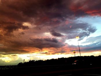 Silhouette of road against dramatic sky