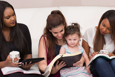 Young woman sitting on book