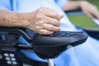 Midsection of patient sitting on wheelchair