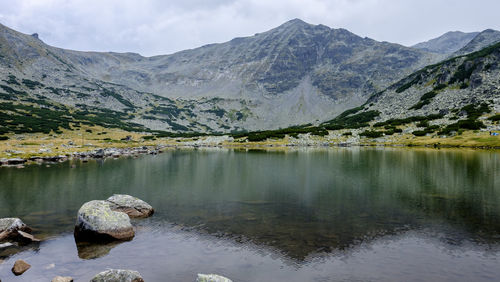 Scenic view of lake and mountains against sky