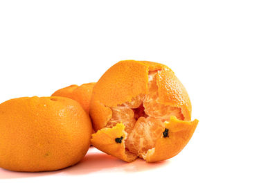 Close-up of orange fruit against white background