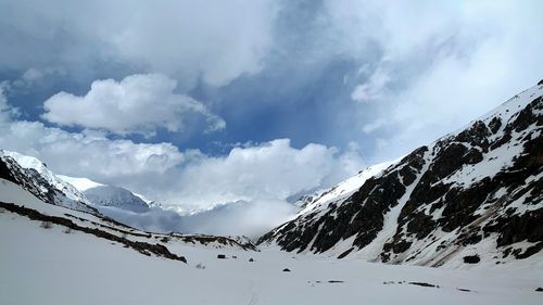 Scenic view of snow covered mountains against sky