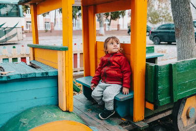 Portrait of cute boy sitting on seat