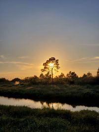 Scenic view of field against sky during sunset