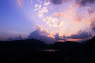 Scenic view of silhouette mountains against dramatic sky