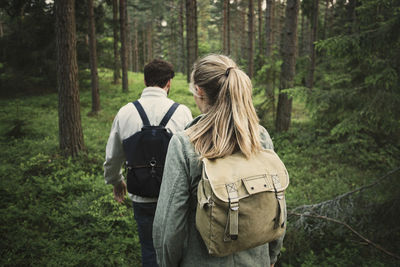 Rear view of couple kissing in forest